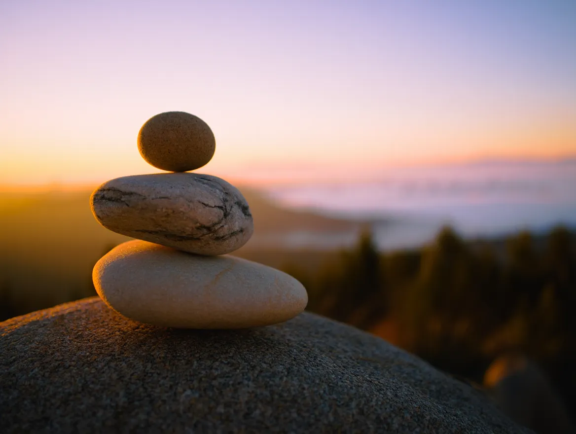 Balanced stones stacked in peaceful harmony representing equilibrium between activity and rest